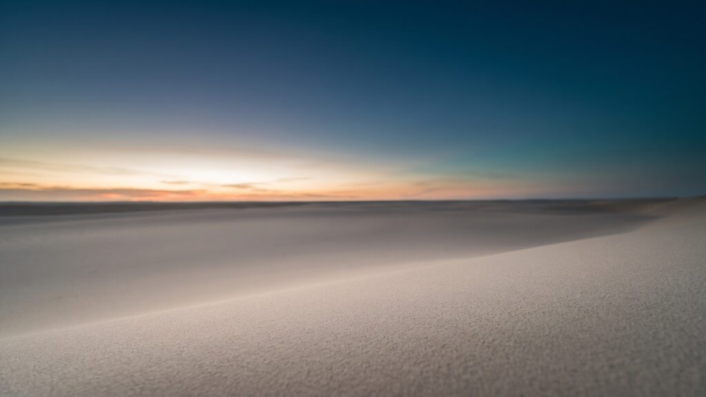A pale horizon over a still empty plain at first light
