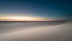 A pale horizon over a still empty plain at first light