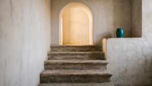Warm light in an arched niche above worn stone steps